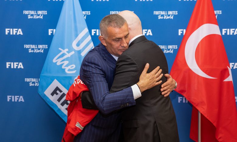 FIFA President Gianni Infantino is presented with a Hakan Çalhanoglu jersey by Turkish Football Federation President Ibrahim Ethem Haciosmanoglu during a meeting between FIFA and meeting with Turkish Football Federation