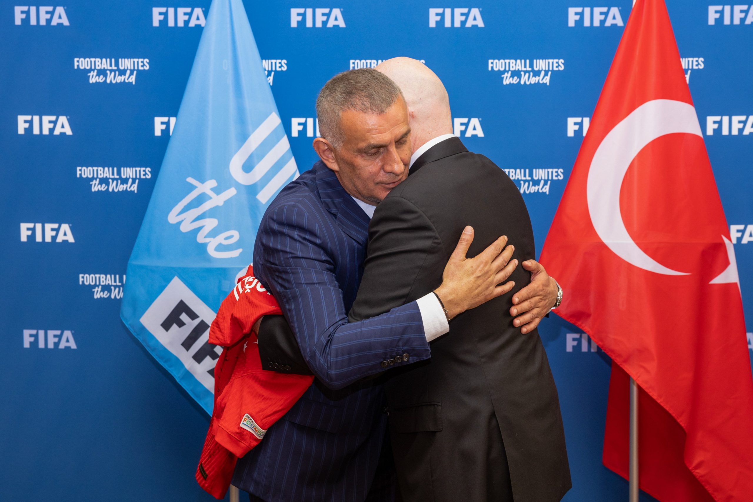 FIFA President Gianni Infantino is presented with a Hakan Çalhanoglu jersey by Turkish Football Federation President Ibrahim Ethem Haciosmanoglu during a meeting between FIFA and meeting with Turkish Football Federation